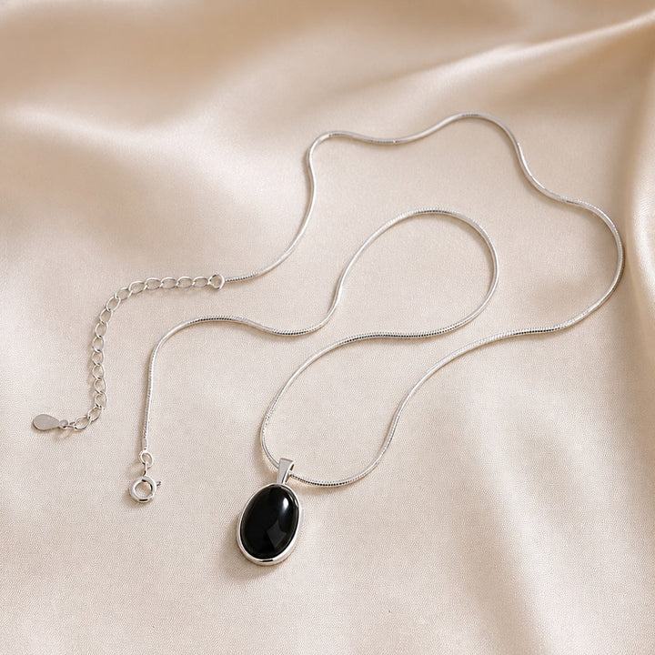 Sophisticated Black Oval Pendant Necklace in White Gold
