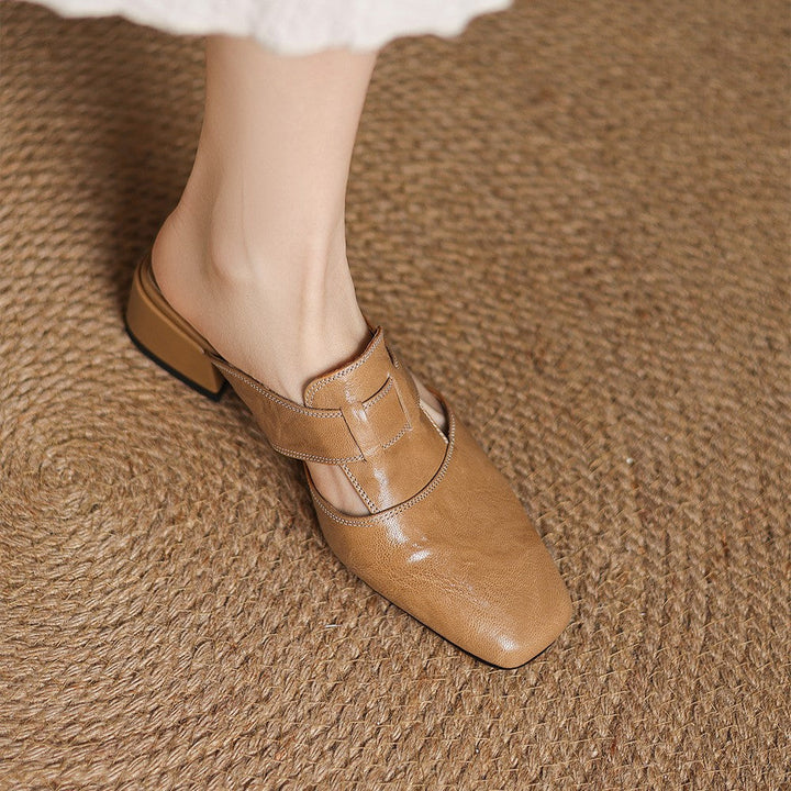Block heel and sole detail of a leather mule