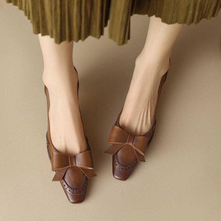Close-up of the bow and brogue detail on a leather pump