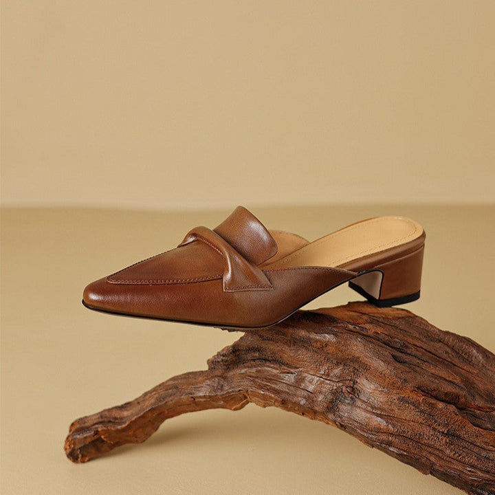 Women's pointed leather mules shown as a pair