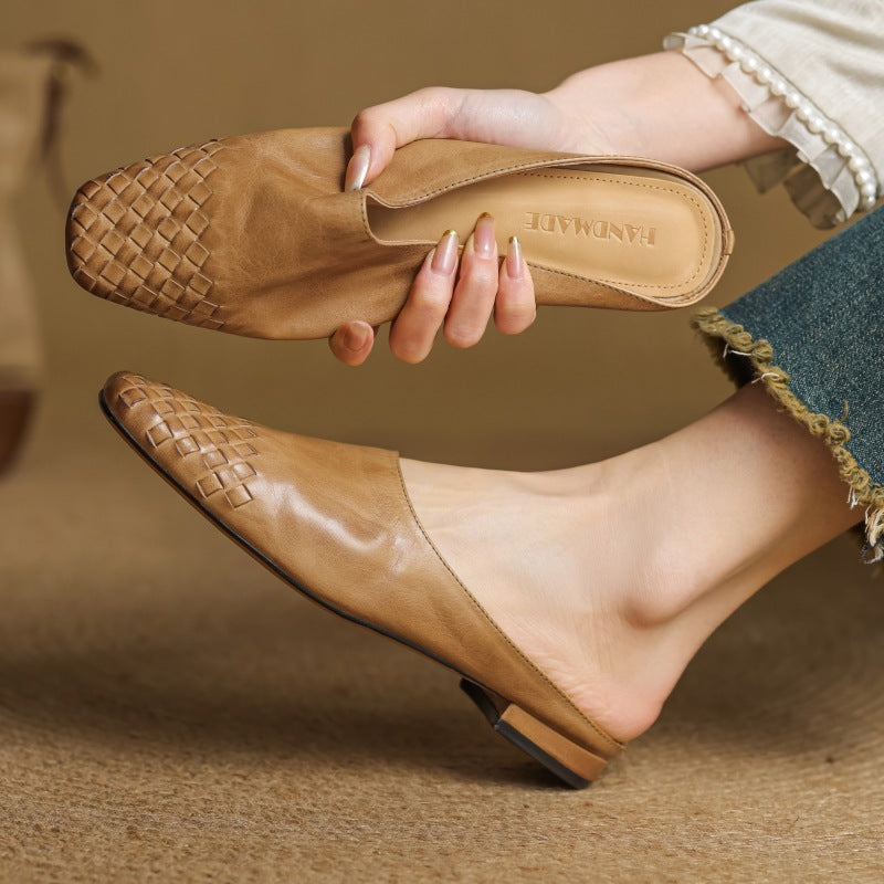 Onyx Black woven leather mules, angled studio shot