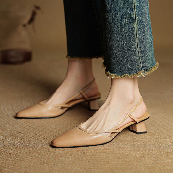 Pauline cross-strap heels worn with a dress