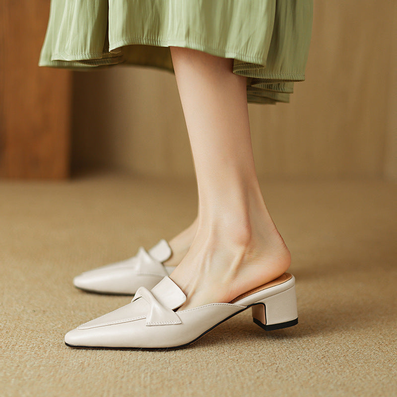 Folded vamp detail on a pointed leather mule