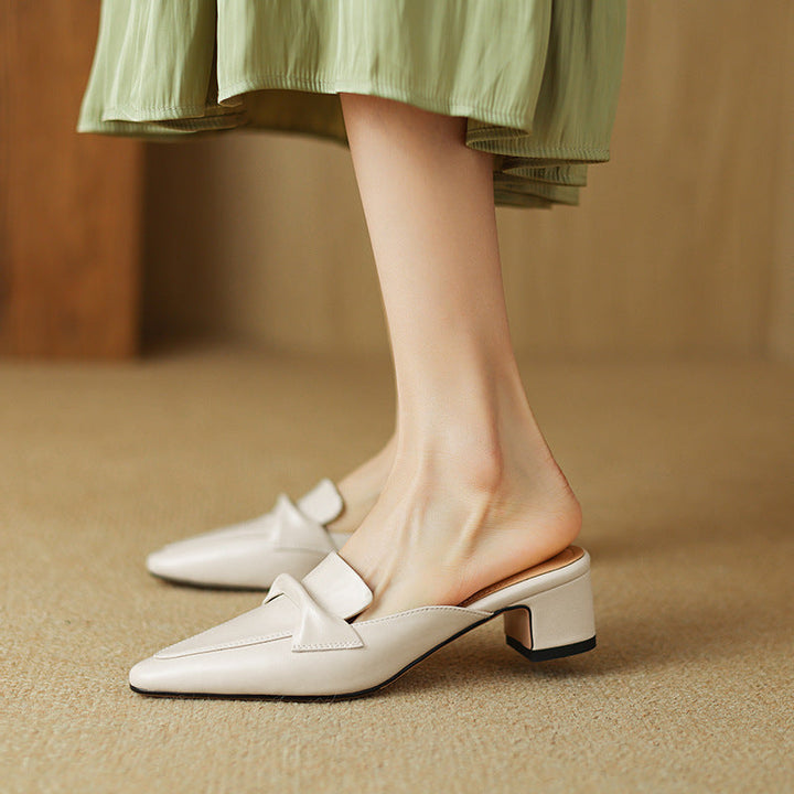 Folded vamp detail on a pointed leather mule