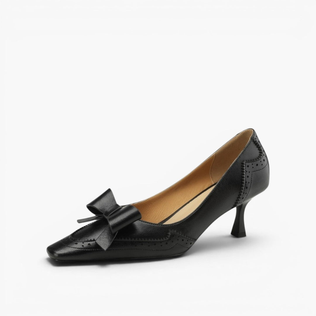Women's bow leather pumps shown as a pair