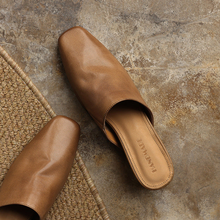 Square-toe leather wedge mules styled with wide-leg trousers