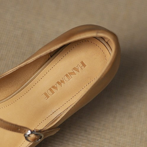 Adjustable strap detail on a leather block heel