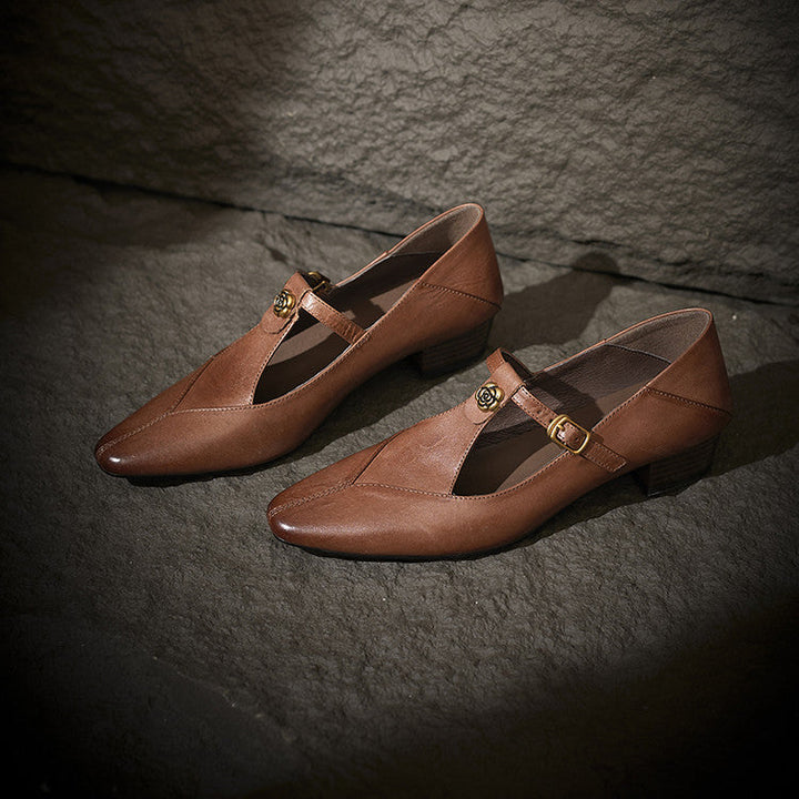 Noir Black leather T-strap pumps, angled studio shot