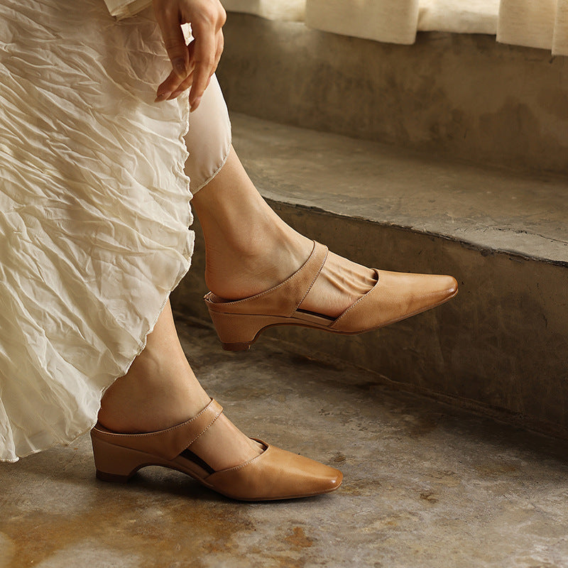 Instep strap and stitching detail on a leather wedge mule