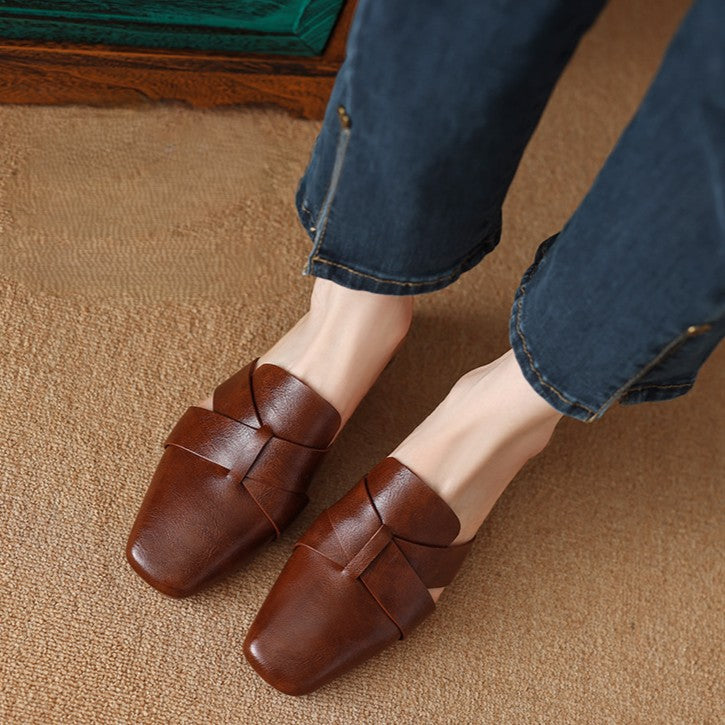 Close-up of smooth leather and cross straps on a square-toe mule