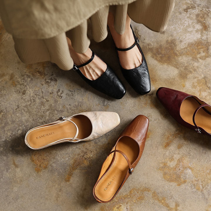Square-toe leather heeled mules styled with tailored trousers