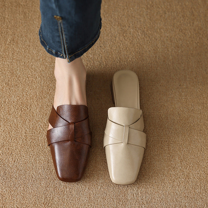Cross-strap leather mules styled with trousers
