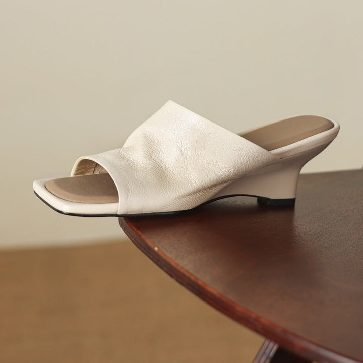 Gloria wedge mules, detail of wide sculpted vamp