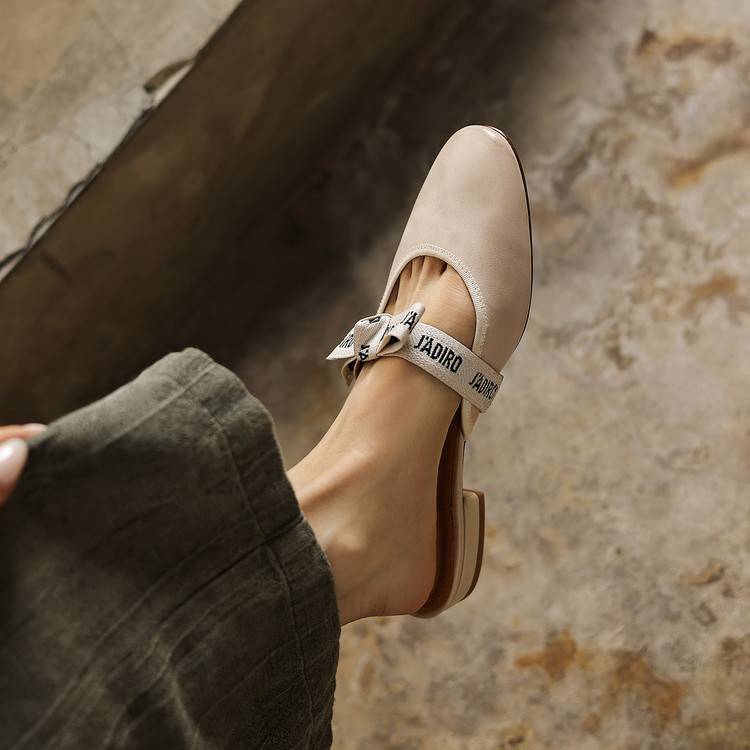 Adele bow mules worn with a midi skirt