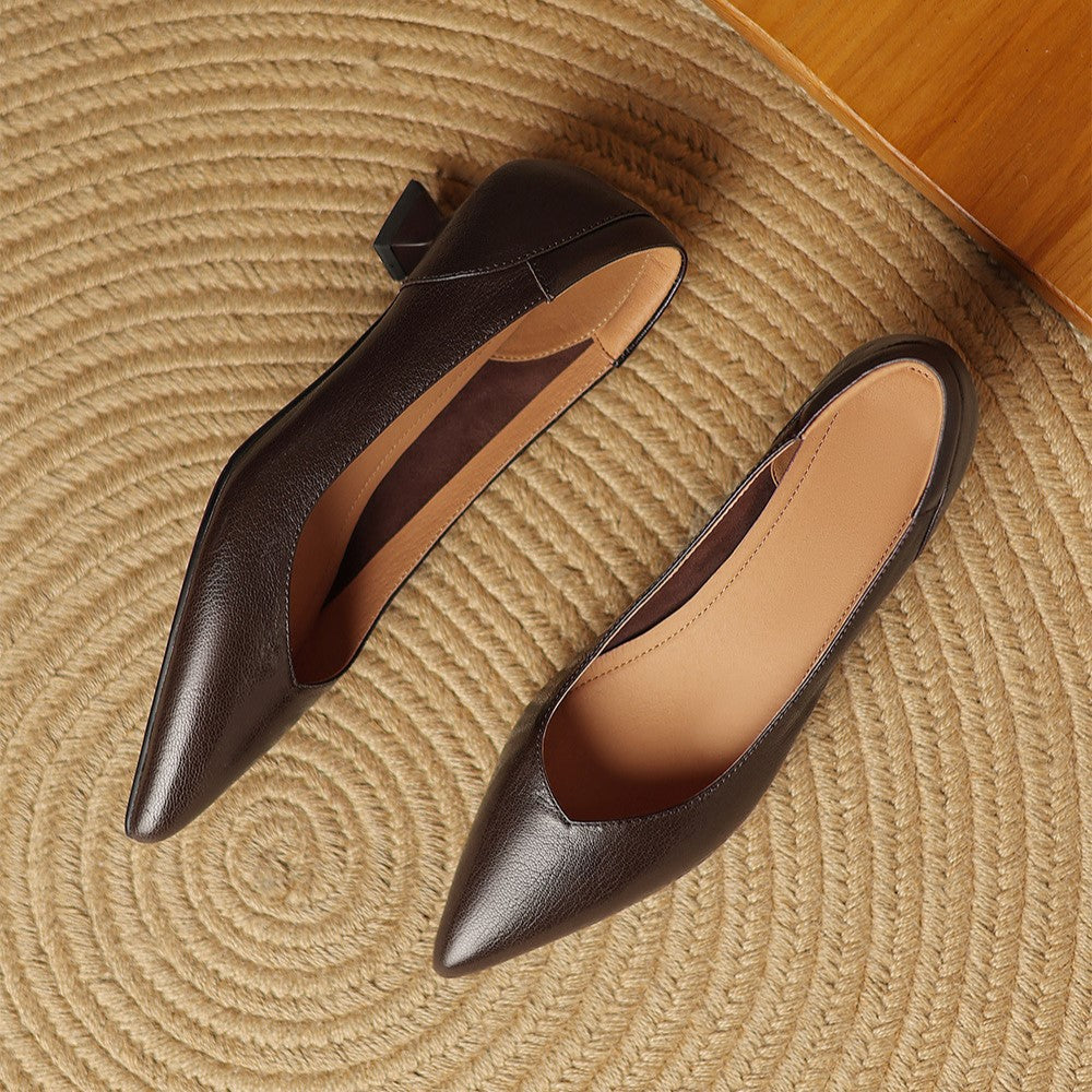Pointed-toe detail of a sculpted leather pump