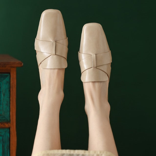 Sculptural cross-strap detail on a leather mule