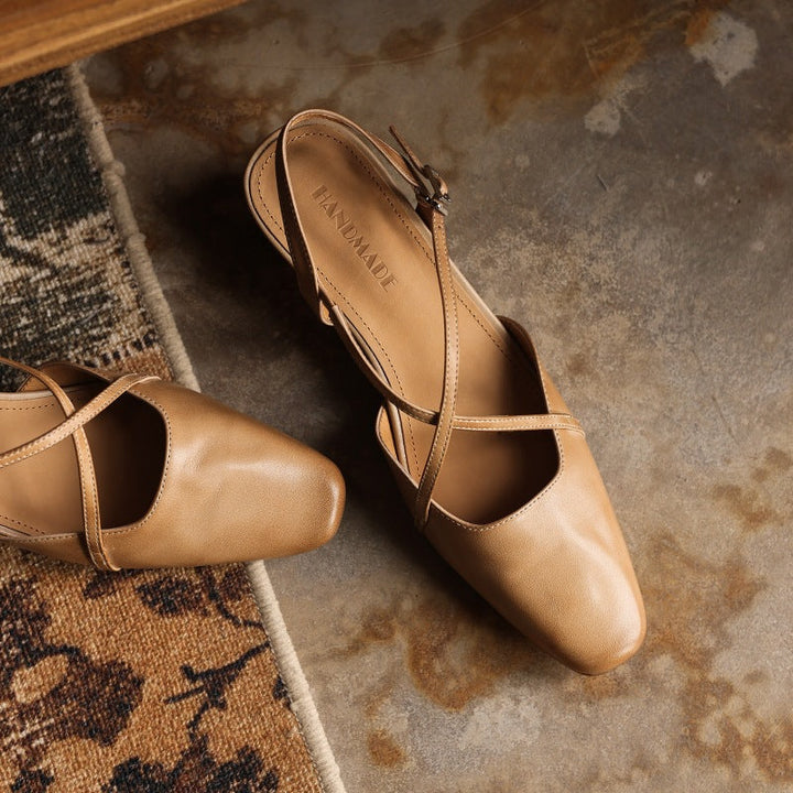 Cross-strap and buckle detail on a leather slingback heel