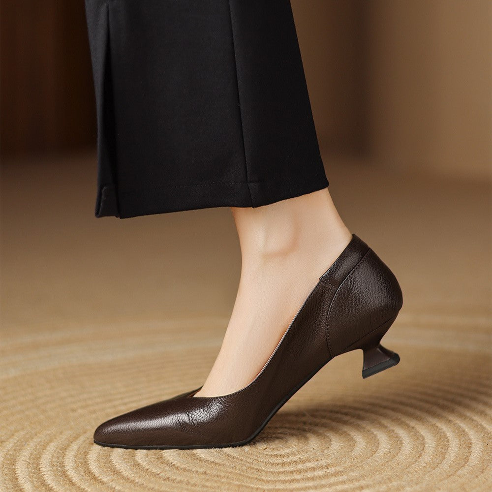 Sculpted geometric heel detail of a leather pump