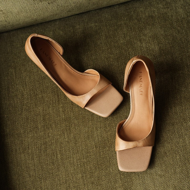 Sculptural heel and d'Orsay cutout detail on a leather sandal