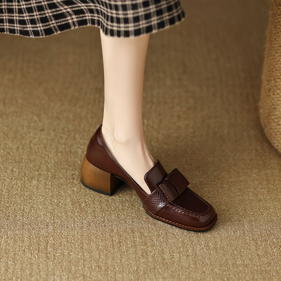 Women's bow leather loafer pumps shown as a pair