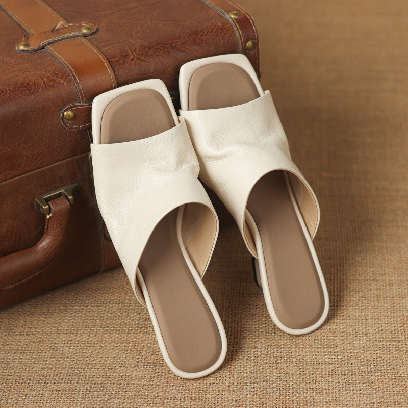 Square-toe leather wedge mules, top view of Soft Ivory pair