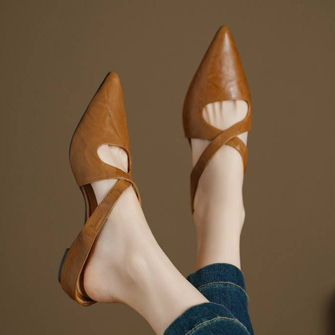Close-up of cowhide leather and cross straps on a pointed mule