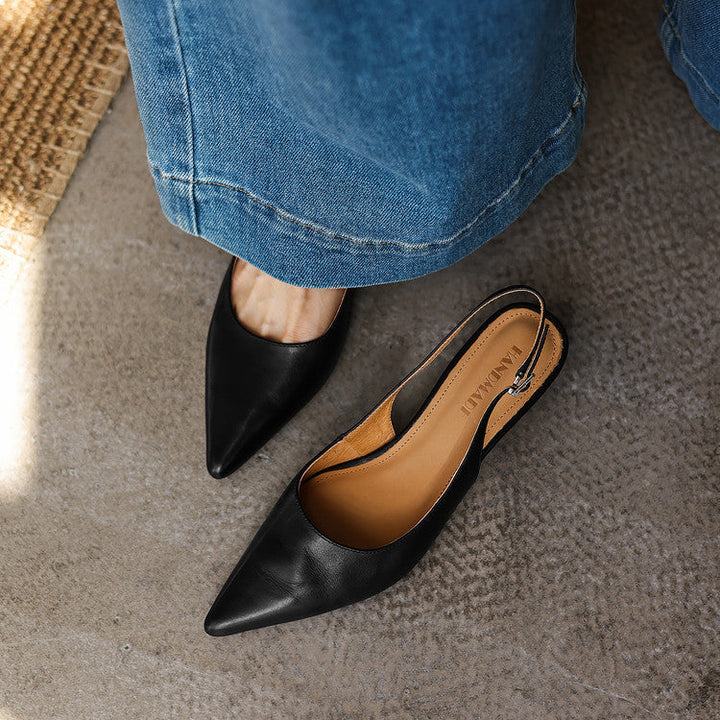 Adjustable slingback strap detail on a leather heel
