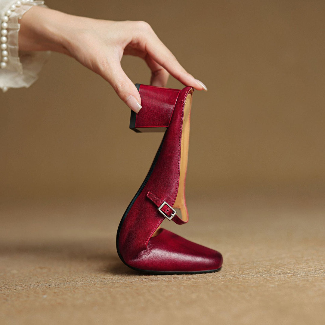 Square-toe leather block mules styled with straight-leg trousers
