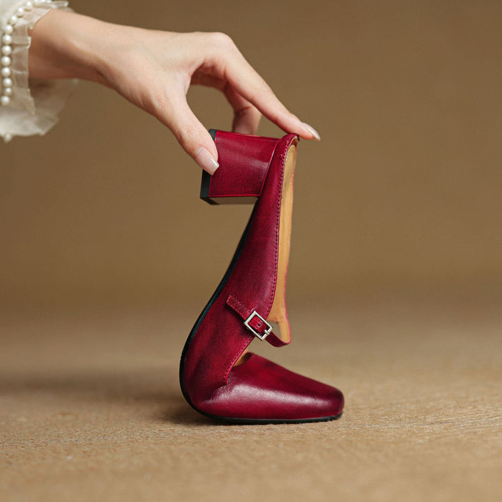 Square-toe leather block mules styled with straight-leg trousers