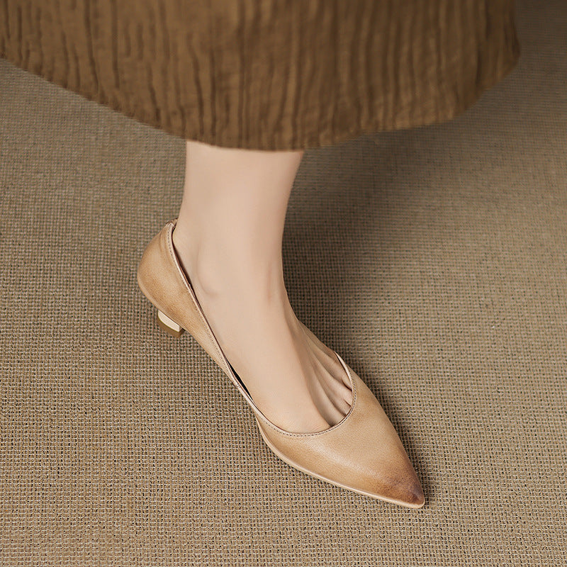 Women's pointed leather pumps shown as a pair