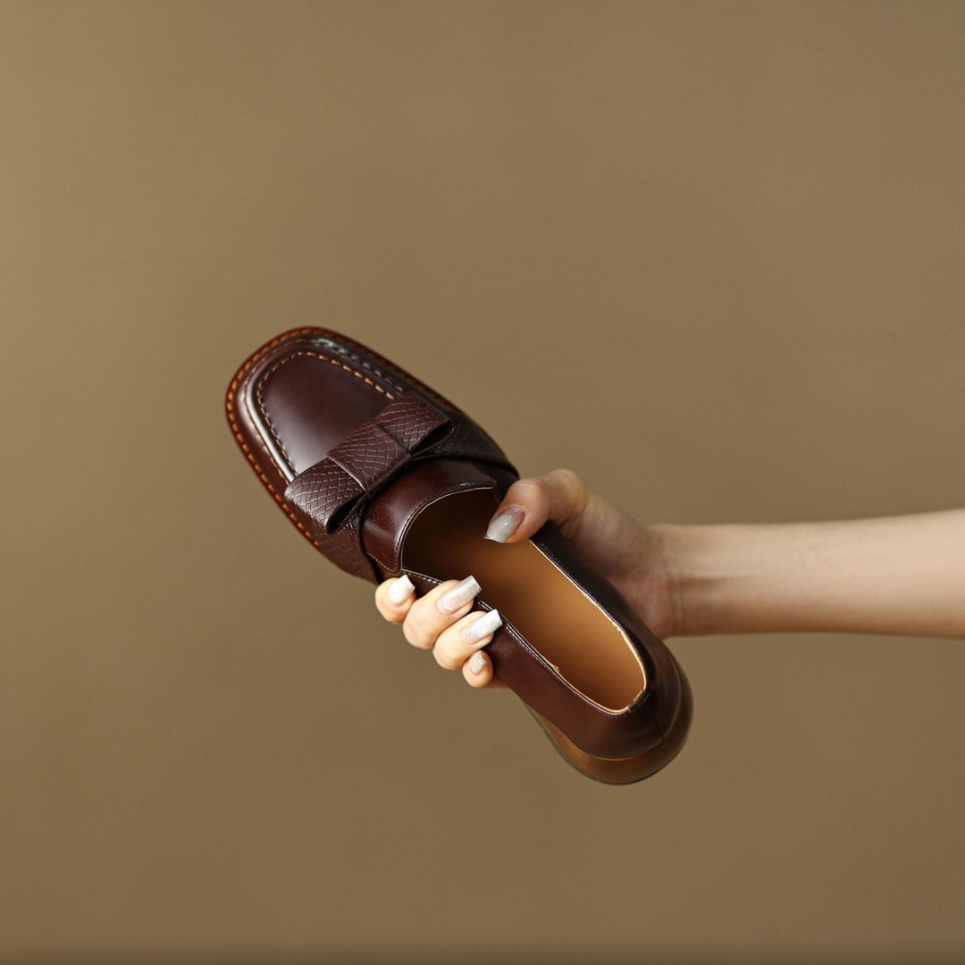 Bow leather loafer pumps styled with a blazer and trousers