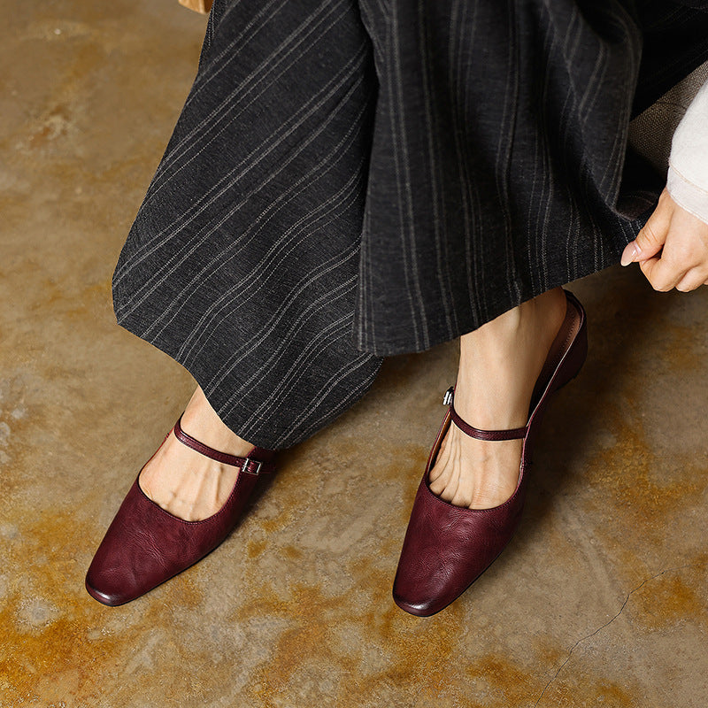 Adjustable strap and cushioned insole of a heeled mule