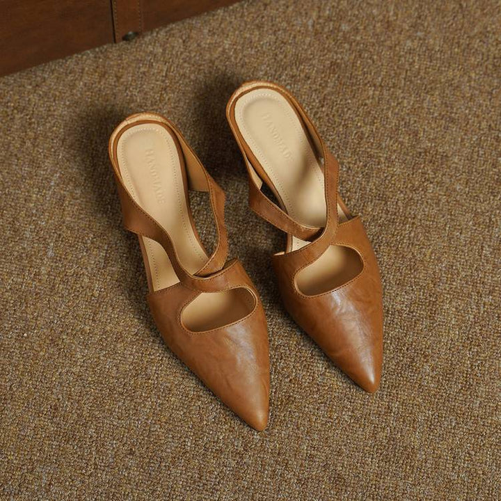 Top-down view of a pointed-toe cross-strap leather mule