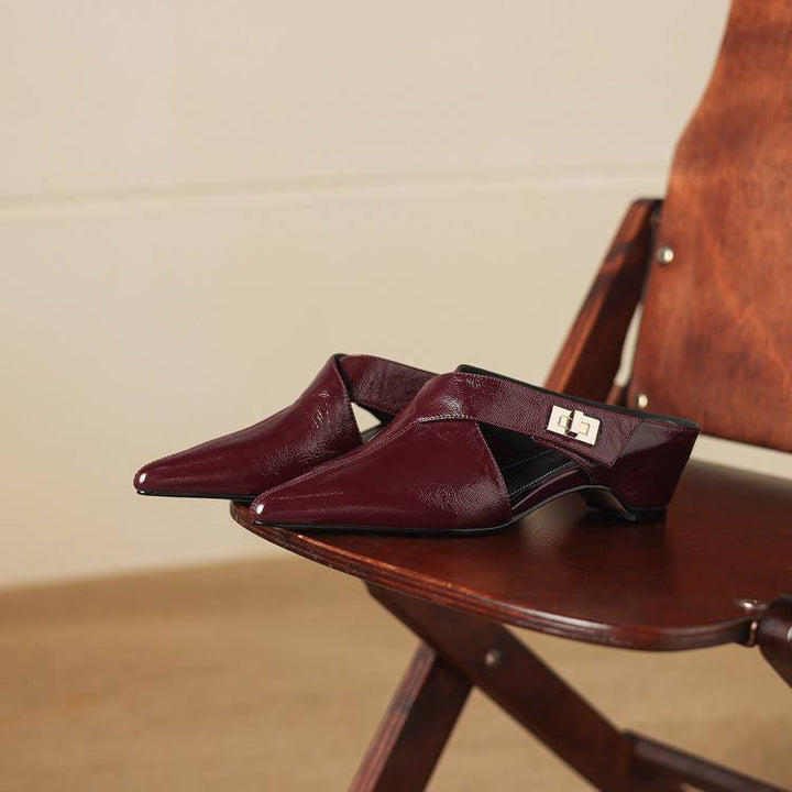 Women's pointed leather heeled mules shown as a pair