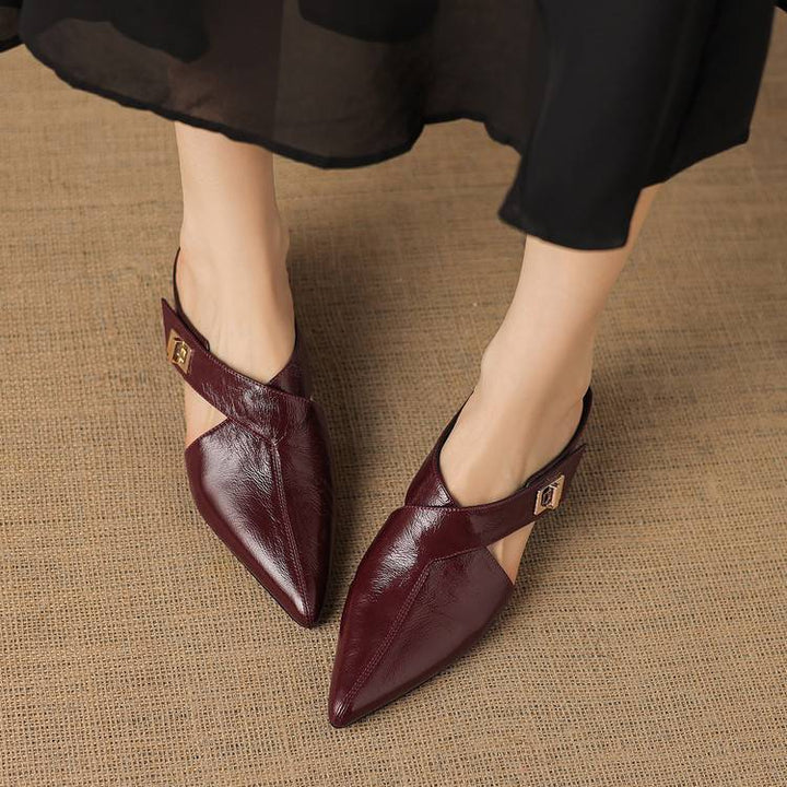 Close-up of lambskin leather and metal accent on a pointed mule