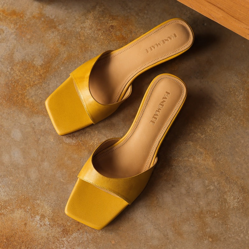 Square-toe leather wedge mules, top view of Warm Ochre pair