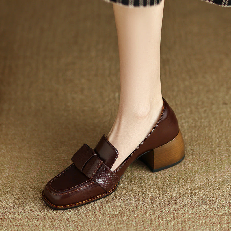 Close-up of smooth leather and textured bow on a loafer pump