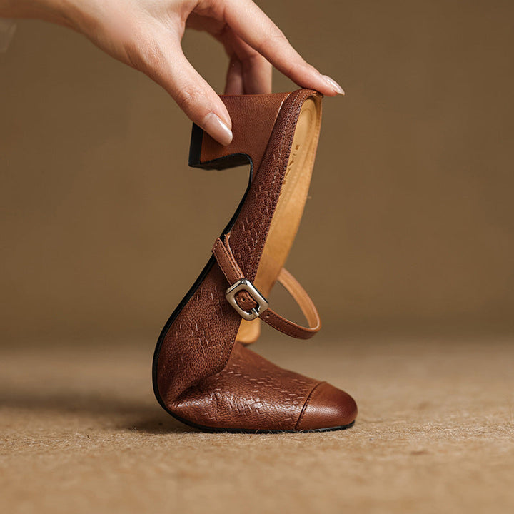 Noir Black embossed leather heeled mules, angled studio shot