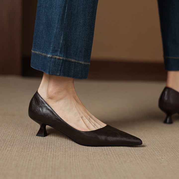 Streamlined pointed-toe detail of a leather low pump