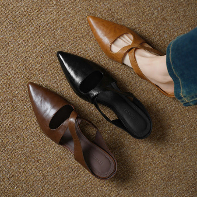 Cross-strap leather mules styled with tailored trousers