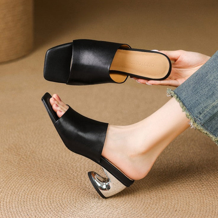 Camilla mules worn with tailored trousers
