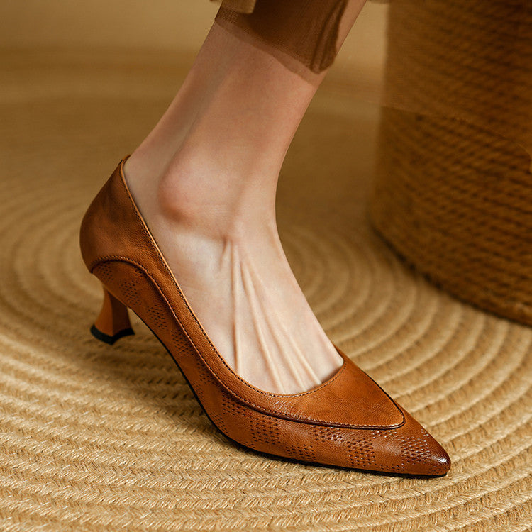 Close-up of washed lambskin leather with perforated detail on a pointed heel