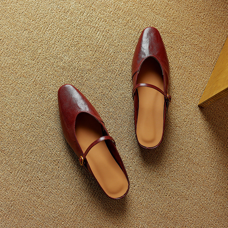 Women's strap leather flat mules shown as a pair