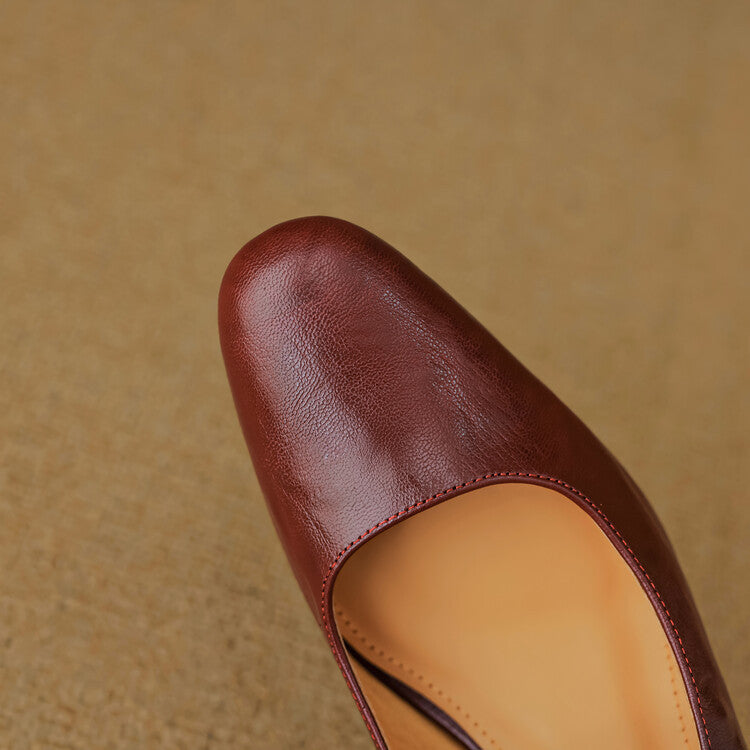 Women's strap leather heeled mules shown as a pair