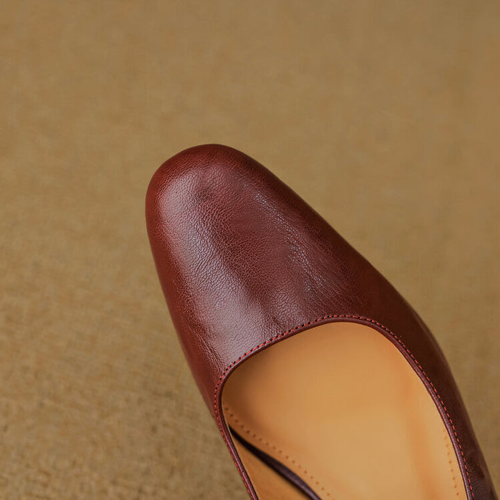 Women's strap leather heeled mules shown as a pair