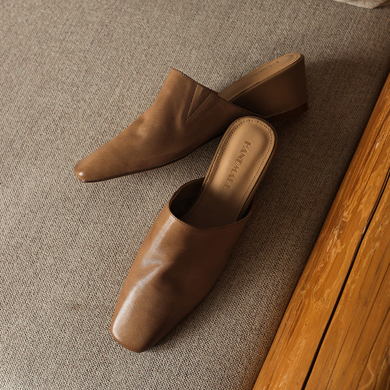 Women's leather wedge mules shown as a pair