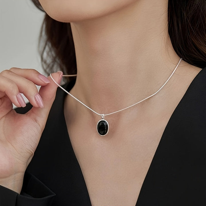 Sophisticated Black Oval Pendant Necklace in White Gold